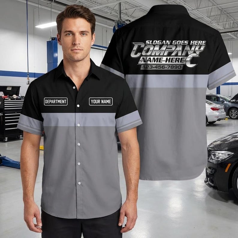May include: A short-sleeved button-down work shirt featuring a black upper section and a gray lower section. The front includes rectangular patches labeled DEPARTMENT and YOUR NAME. The back displays the text SLOGAN GOES HERE COMPANY NAME HERE.