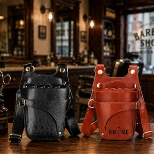 May include: Two holster-style pouches, one black and one brown, featuring multiple compartments for tools. Each pouch has gold-tone metal rivets, adjustable straps with buckles, and embossed text on the front. The black pouch displays the text Power M, while the brown pouch features the text KH MC.