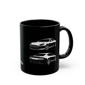 May include: Black ceramic mug featuring white line art illustrations of two sports cars. The top car is viewed from the front, and the bottom car is viewed from the rear. The mug has a curved handle and a glossy finish.