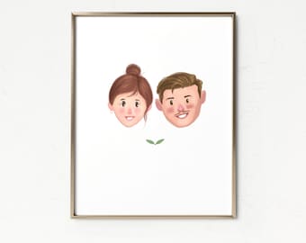 May include: A framed watercolor portrait featuring two smiling faces. The woman has brown hair in a bun, and the man has brown hair and a mustache. Two small green leaves are below the faces. The frame is gold.
