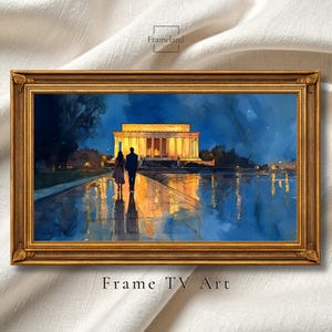 May include: A framed watercolor print depicts a couple walking towards a brightly lit building at night. The artwork features a gold frame and the text "Frame TV Art" at the bottom. The scene is reflected in the water.
