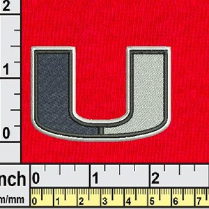 May include: Embroidered patch in the shape of the letter "U", with a dark blue and light gray design, outlined in black and white. The patch is approximately 2 inches (5 cm) tall and is set against a red background.