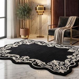 May include: A black area rug with an ornate, cream-colored border. The rug has a unique, scalloped shape and is placed on a marble floor. The room features a modern chair, side table, and a floor lamp, creating a luxurious atmosphere.