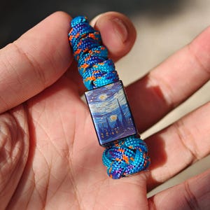 Starry Sky Lanyard Bead, hand-carved from titanium alloy, and comes with a free paracord lanyard