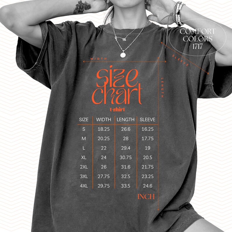 May include: A charcoal grey short-sleeve t-shirt featuring an orange size chart graphic with the text Comfort Colors 1717. The chart lists sizes S through 4XL with corresponding width, length, and sleeve measurements in inches for each size.