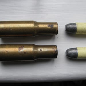 A pair of Martini Henry brass and lead display items.