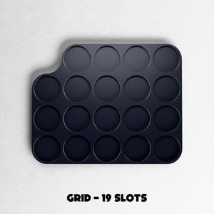 May include: A dark navy blue grid with 19 circular slots. The grid has a rounded rectangular shape with a curved edge on the left side. The text "GRID - 19 SLOTS" is printed in black at the bottom of the image.