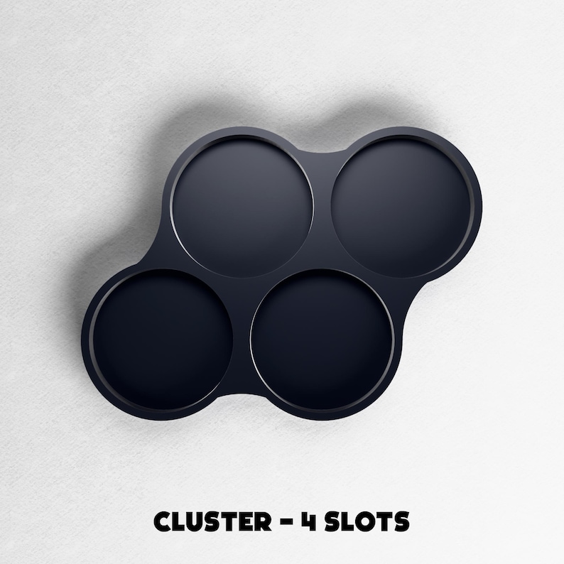 May include: A dark navy blue cluster with four circular slots. The slots are arranged in a unique pattern, with three slots clustered together and one separate. The text "CLUSTER - 4 SLOTS" is at the bottom of the image.