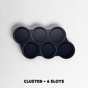 May include: A dark navy blue cluster with six circular slots. The slots are arranged in a curved pattern. The text "CLUSTER - 6 SLOTS" is printed in bold, black letters at the bottom of the image.