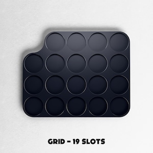 May include: A dark navy blue grid with 19 circular slots. The grid has a rounded rectangular shape with a curved edge on the left side. The text "GRID - 19 SLOTS" is printed in black at the bottom of the image.