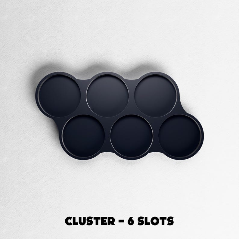 May include: A dark navy blue cluster with six circular slots. The slots are arranged in a curved pattern. The text "CLUSTER - 6 SLOTS" is printed in bold, black letters at the bottom of the image.