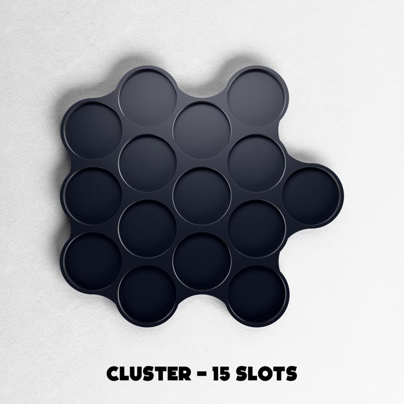May include: A dark navy blue cluster organizer with 15 circular slots. The product is on a white background. The text "CLUSTER - 15 SLOTS" is printed in bold, black letters at the bottom of the image.