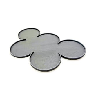 May include: A dark gray, four-leaf clover-shaped trivet with a textured surface and a raised edge. The trivet is made of a durable material and is designed to protect surfaces from heat.