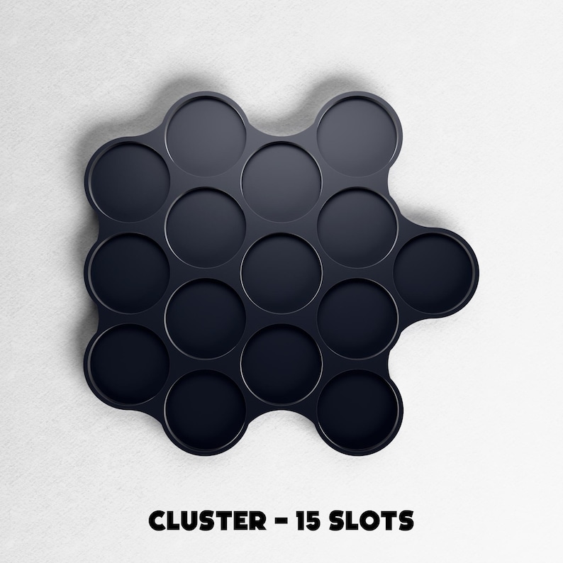 May include: A dark navy blue cluster organizer with 15 circular slots. The organizer is on a white background. The text "CLUSTER - 15 SLOTS" is printed in black at the bottom of the image.