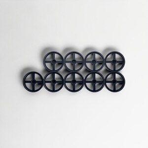 May include: Nine dark navy blue, wheel-shaped objects arranged in a grid pattern. Each wheel has a central hub with four spokes extending outwards. The objects are evenly spaced against a white background, casting subtle shadows.