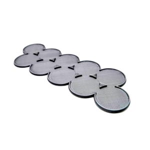 May include: A gray, flower-shaped object with a textured surface and small, triangular accents. The object is made of a solid material and is set against a white background. The design is modern and minimalist.