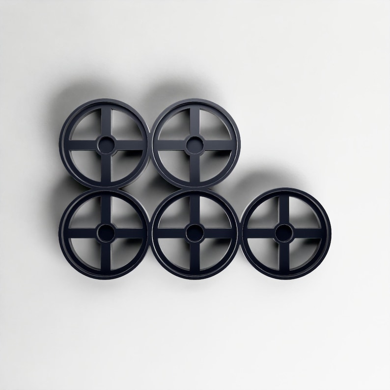May include: Six dark blue circular objects with a cross-shaped design, arranged in a geometric pattern against a white background. The objects are evenly spaced. The design is modern and minimalist.