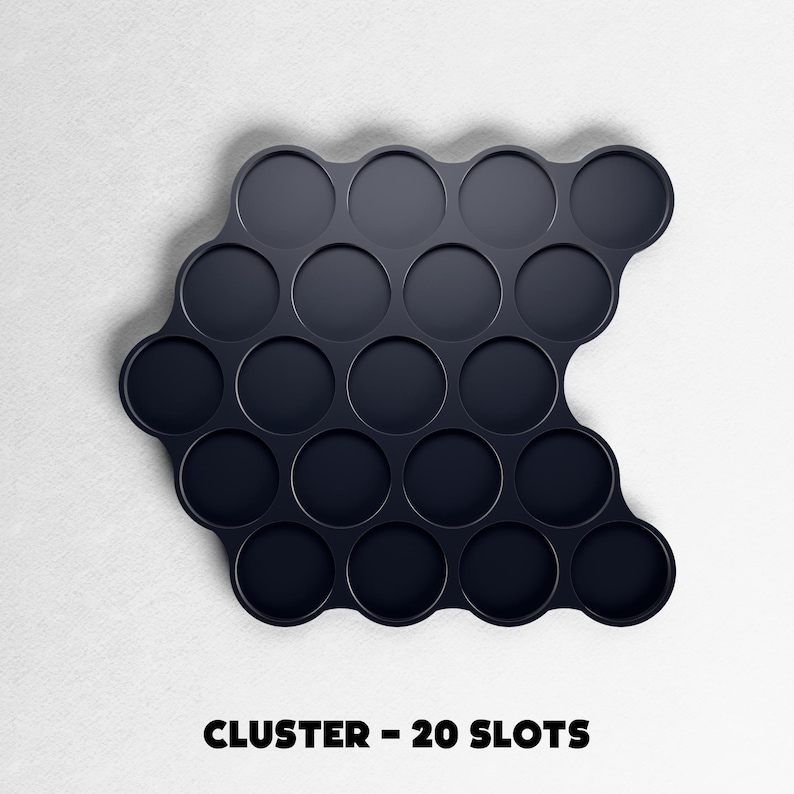 May include: A dark navy blue cluster tray with 20 circular slots. The tray has a unique, curved shape and is designed to hold small items. The text "CLUSTER - 20 SLOTS" is printed in black at the bottom of the image.