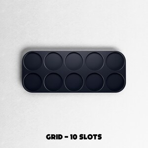 May include: A dark navy blue grid with ten circular slots. The grid has rounded corners and is set against a white textured background. The text "GRID - 10 SLOTS" is printed in black at the bottom of the image.