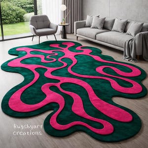 May include: An irregularly shaped area rug featuring a deep forest green base with a vibrant hot pink abstract, fluid, and winding pattern across the surface. The text Rugsbyart creations is printed in white in the bottom left corner of the rug.