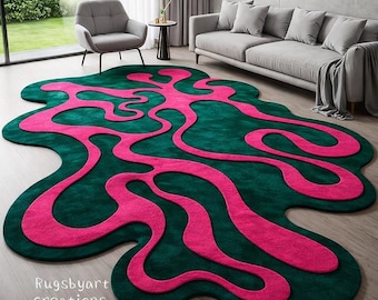 May include: A large, abstract area rug with a dark green background and a vibrant pink, flowing design. The rug's unique shape and color scheme create a modern, eye-catching statement piece for any living space.