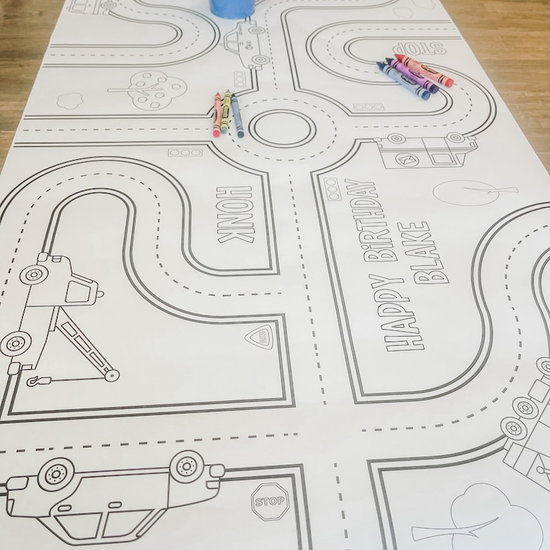 May include: A black and white colouring page featuring a road course with cars, stop signs, and the text "Happy Birthday Blake".