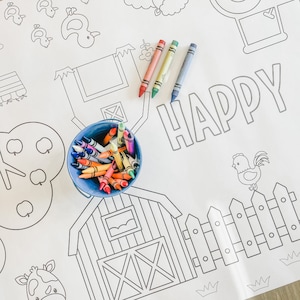 May include: A white colouring page with a farm theme. The page features a barn, a fence, a rooster, a cow, and a bucket of crayons. The word "HAPPY" is written in large letters at the top of the page.