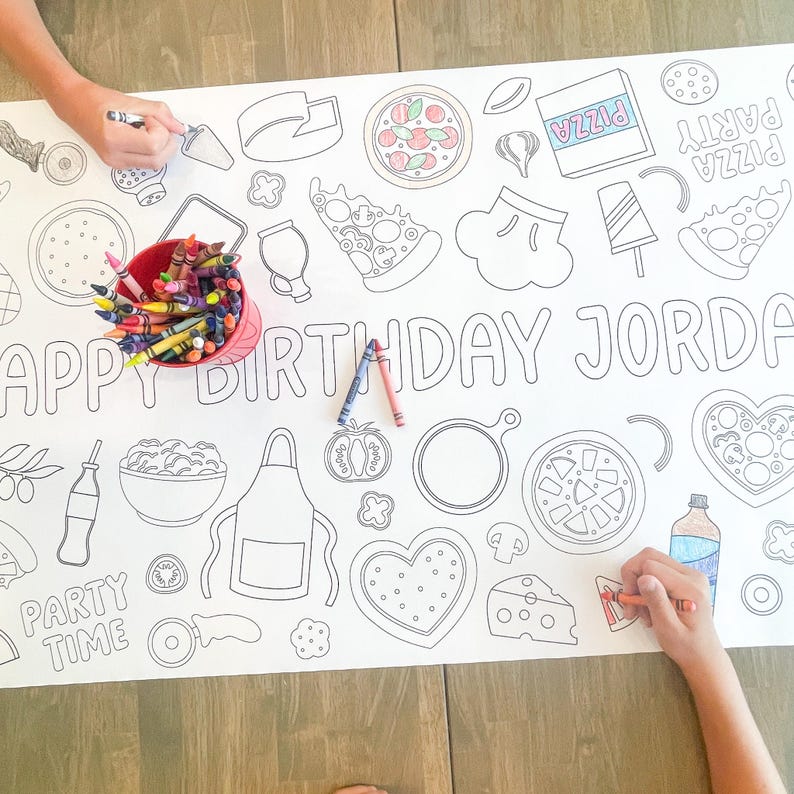 A large white paper coloring sheet with pizza-themed illustrations and the text "HAPPY BIRTHDAY JORDAN". A red bucket of crayons and two people coloring the sheet are visible.