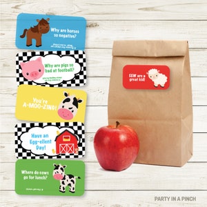 May include: Five colourful cards with farm animal illustrations and puns. The cards have a chequered background. A brown paper lunch bag with a red card attached to it that says "EEW are a great kid!" and has a white sheep illustration. A red apple is in front of the bag.