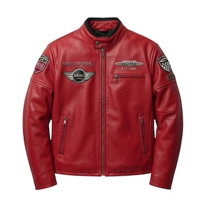 May include: A red leather jacket with a stand-up collar and a zipper closure. The jacket features multiple embroidered patches, including "MINI COOPER" and "WORKS EST 2000". The jacket has two zippered pockets and a black lining.