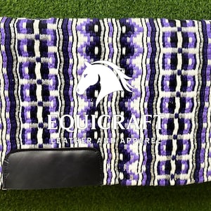 May include: A horse saddle pad with a geometric pattern in purple, white, and black. The pad features a black leather patch at the bottom and the text "EQUICRAFT LEATHER AND APPAREL" with a horse head logo.