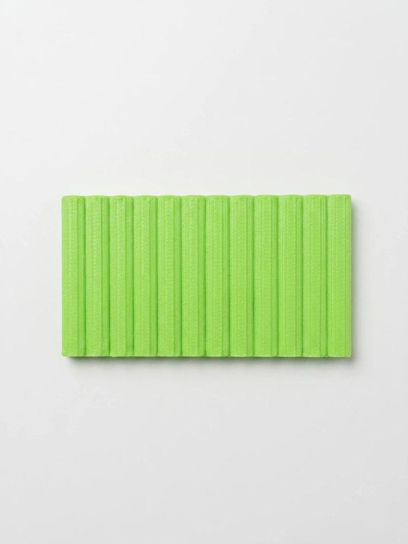 May include: A rectangular, lime green yoga mat with vertical ribbed texture. The mat is made of a flexible material and is designed for exercise and stretching. The bright color adds a vibrant touch to any workout space.