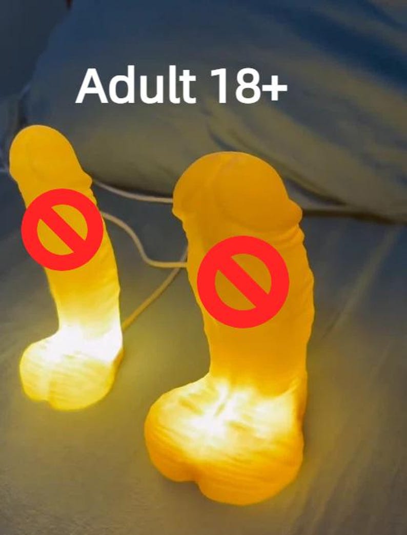 May include: A white ceramic mug with a black handle and the text "But First, Coffee" in a bold, black font. The mug is set against a blurred background, suggesting a cozy setting.