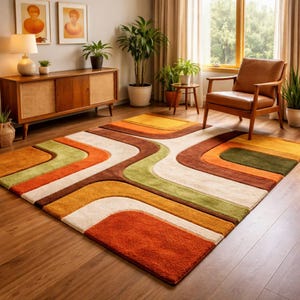 May include: A rectangular area rug featuring a geometric pattern of curved, interlocking bands in shades of burnt orange, olive green, brown, and cream. The rug has a thick, textured pile and is positioned on a wooden floor in a room setting.