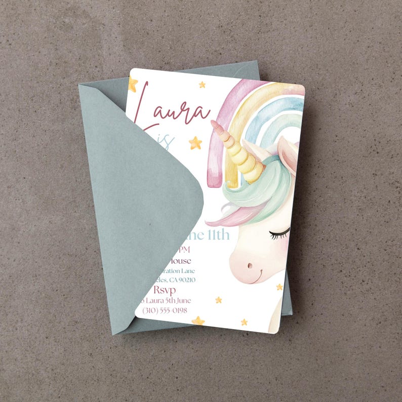 May include: A pastel unicorn invitation card with a rainbow and stars, inside a pale blue envelope. The card features the text "Laura" and event details. The unicorn has a golden horn and a flowing mane.