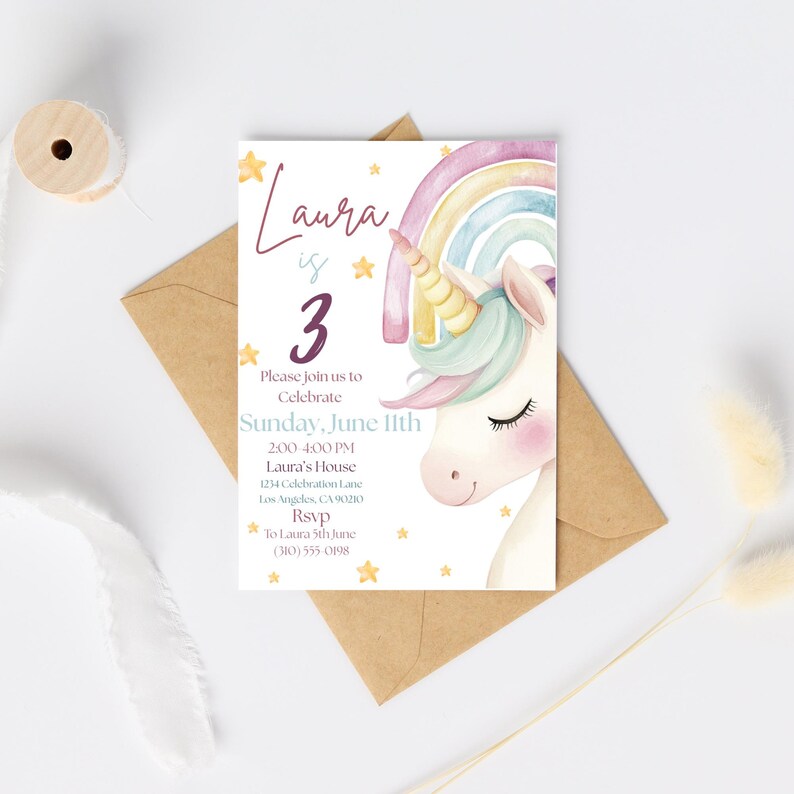 May include: A birthday party invitation featuring a watercolour unicorn with a rainbow and stars. The invitation reads "Laura is 3" and includes event details. The invitation is on a white background with a brown envelope.
