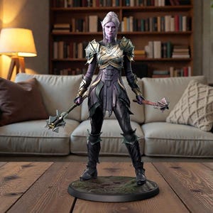 May include: A detailed figurine of a female warrior with pale skin and white hair, clad in armor with gold and green accents. She holds two weapons and stands on a circular base, set against a living room backdrop.