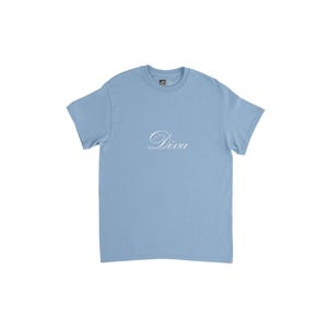 May include: A pale blue t-shirt featuring the word "Diva" in a cursive script. The top has a crew neck and short sleeves. The material looks to be a soft cotton mix.