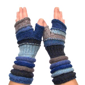 May include: A pair of blue, gray, and black fingerless gloves with a striped pattern. The gloves are knitted and have a cuff that extends to the wrist.