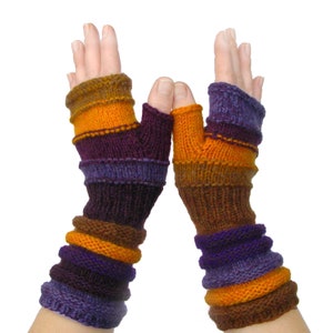 May include: A pair of knitted fingerless gloves in a vibrant color palette. The gloves feature horizontal stripes of brown, orange, purple, and blue. The wrist cuffs are ribbed, and the thumb holes are visible.