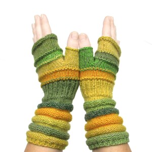 May include: A pair of fingerless gloves with a striped pattern in shades of green and yellow.