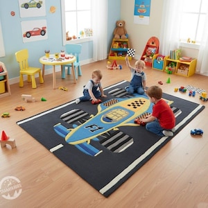 May include: A dark gray rectangular rug with a large blue and yellow race car design. The rug has white stripes along the edges, resembling a racetrack. Three children are playing with toy cars on the rug in a brightly lit playroom.