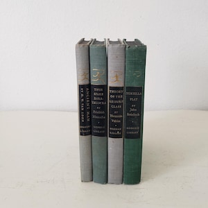 May include: Four vintage paperback books with green, blue, and gray covers. The titles are "Ancient Man" by H.W. Van Loon, "Thus Spake Zara-Thustra" by Friedrich Nietzsche, "Theory of the Leisure Class" by Thorstein Veblen, and "Tortilla Flat" by John Steinbeck. All books are part of the "Modern Library" series.