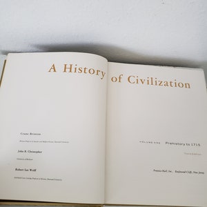 May include: A book titled "A History of Civilization" by Crane Brinton, John B. Christopher, and Robert Lee Wolff. The book is volume one, covering prehistory to 1715, and is the third edition.