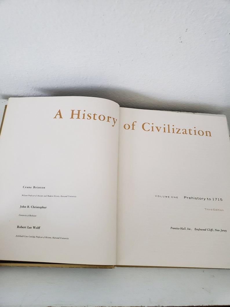 May include: A book titled "A History of Civilization" by Crane Brinton, John B. Christopher, and Robert Lee Wolff. The book is volume one, covering prehistory to 1715, and is the third edition.