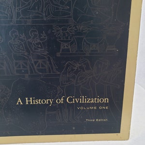 May include: A black book cover with gold lettering that reads "A History of Civilization, Volume One, Third Edition". The cover features a black and white illustration of people in ancient Egyptian clothing.