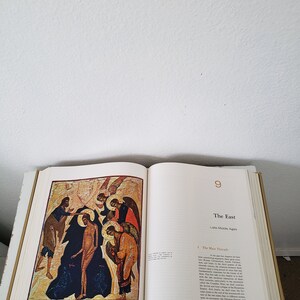 May include: An open book with a colorful illustration of a religious scene. The book is titled "The East" and the page number is 9. The text on the page discusses the "Main Threads" of the Late Middle Ages.