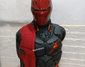 May include: A Red Hood cosplay bust featuring a metallic red helmet, a black armored chest piece with a red star emblem, and a red and black jacket. The text SapCoStore is visible on the chest. The armor has detailed paneling and textures.