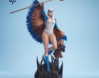 May include: A detailed figurine of a female character with blue and brown feathered wings, a white bodysuit, and blue boots, holding a staff with a crescent moon. A small brown creature stands nearby. The figurine is on a dark base against a light blue background.