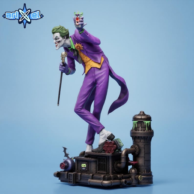 Puede incluir: Figura detallada del Joker con traje morado, pelo verde y maquillaje blanco, sosteniendo un bast&oacute;n y una bebida. La figura se encuentra sobre una base mec&aacute;nica con una torre, tuber&iacute;as y un s&iacute;mbolo de murci&eacute;lago. El logo de Arikel est&aacute; arriba a la izquierda.